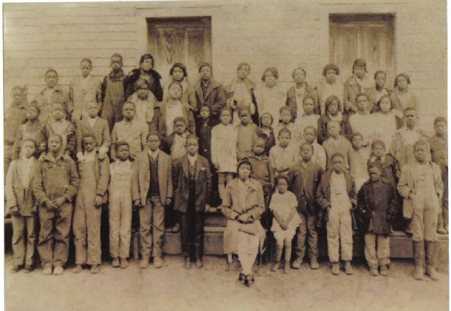 Victoria Rice Crawford-Leake in front of Enon Springs School